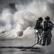 Firefighters standing in front of smoke